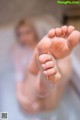 A close up of a person's feet in a bathtub.